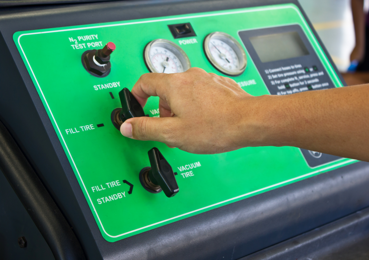Hand operating tire inflation control panel.